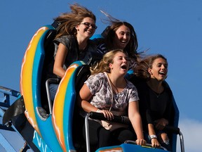 Fair goers ride the Blitzer roller coaster on the K-Days midway, in Edmonton Alta. on Thursday July 23, 2015. David Bloom/Edmonton Sun/Postmedia Network