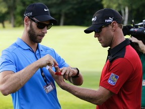 Graham DeLaet gets his left thumb taped during first round action at the Canadian Open at Glen Abbey Golf Course in Oakville, Ont., on Thursday, July 23, 2015. DeLaet withdrew from the tournament on Friday. (Craig Robertson/Postmedia Network)