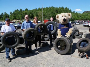 Ron Cayer, left, of Rock City Auto Supplies, is joined by Steve Fletcher, of the Ontario Automotive Recyclers Association, Heidi Spannbauer, of the Sunshine Foundation of Canada, Andrew Horsman, of the Ontario Tire Stewardship, Sunshine Bear and Sarah Lashbrook, Greater Sudbury chapter president of the Sunshine Foundation, at a special presentation at Cayer's business in Sudbury, Ont. on Thursday July 23, 2015. Rock City was recognized for collecting the most tires during the province-wide Tire Take Back Recycling Blitz fundraiser for the Sunshine Foundation of Canada, which was held from June 1-6. Rock City collected 14,837 tires and raised more than $26,000 for the Sunshine Foundation. In total, more than $115,000 was raised province-wide for the Sunshine Foundation. John Lappa/Sudbury Star/Postmedia Network