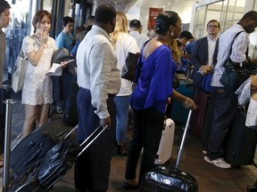 Travellers wait in line at Terminal D after a power outage affected sections of Terminal C at LaGuardia International Airport in New York July 24, 2015.  REUTERS/Shannon Stapleton