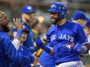 Toronto Blue Jays outfielder Jose Bautista (right) celebrates with Jose Reyes after hitting a home run against the Oakland Athletics at O.co Coliseum on July 21, 2015 in Oakland. (Thearon W. Henderson/Getty Images/AFP)