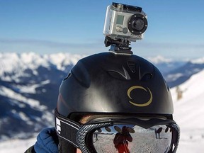 A GoPro camera is seen on a skier's helmet as he rides down the slopes in the ski resort of Meribel, French Alps, Jan. 7, 2014.  REUTERS/Emmanuel Foudrot