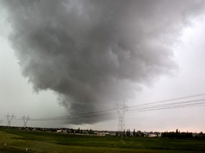 A dark ominous cloud forms over the southwest-end of Edmonton at 2:42pm during a Tornado watch that was issued for Edmonton and surrounding communities on Wednesday June 12, 2013. The photo was taken from 111 St., and Anthony Henday looking north. Tom Braid/Edmonton Sun/QMI Agency
