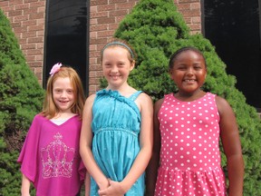 Rileigh Klassen, Kaydence Crone-Moore and Olivia Vandenbogaerde are looking forward to sharing what they learned about food security during a community corn roast on Aug. 8 at the Portuguese Club in Chatham. Students from Queen Elizabeth II Public School are partnering with the C-K Table and the Portuguese Folklore Dance Club to host a community celebration of local food and culture. Blair Andrews/Postmedia Network