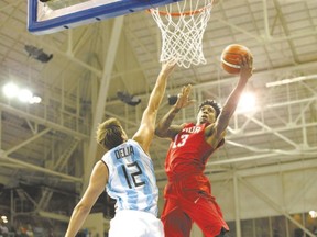 Canada?s Daniel Waldin, right, scores over Argentina?s Marcos Delia during the men?s basketball at the Pan Am Toronto 2015 games in Toronto this week at the Ryerson Athletic Centre. (Chris Young/The Canadian Press)