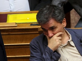 Greek Finance Minister Euclid Tsakalotos reacts during a parliamentary session in Athens, Greece July 15, 2015. A lot of the measures in a deal struck with Greece's lenders will have a recessionary effect but removing the prospect of a "Grexit" will help offset their impact and bring in investments, Tsakalotos said on Wednesday.  REUTERS/Yiannis Kourtoglou