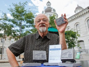 Peter Gilmore, owner of Stone City, holds one of the new limestone souvenir paperweight he's selling in Kingston, Ont. on Thursday July 23, 2015. Gilmore is looking to give back to the community with part of the proceeds from the souvenir sale going to the Kingston Youth Shelter. Julia McKay/The Kingston Whig-Standard/Postmedia Network