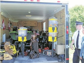 Samantha Reed/For The Intelligencer 
Detective Sergeant Jennifer Patton and Staff Sgt. Peter Valiquette look into a OPP trailer full of stolen merchandise at Central Hastings OPP detachment Friday afternoon. The estimated $40,000 worth of property was obtained by officers from a residence in Belleville.