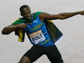 Usain Bolt of Jamaica celebrates after winning the 100-metre final during the Diamond League athletics meeting in the Queen Elizabeth Olympic Park in London, Friday, July 24, 2015. (AP Photo/Kirsty Wigglesworth)