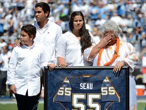 The family of Linebacker Junior Seau #55 of the San Diego Chargers celebrate the life of their son and retire his jersey before the game against the Tennessee Titans on September 16, 2012 at Qualcomm Stadium in San Diego, California. (Donald Miralle/Getty Images/AFP)