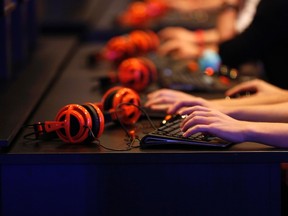 Gamers play "Warlords of Draenor" at the World of Warcraft exhibition stand during the Gamescom 2014 fair in Cologne August 13, 2014. (REUTERS/Ina Fassbender)