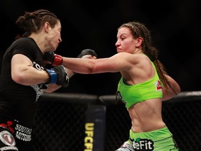 Miesha Tate (R) punches Sara McMann in their bantamweight bout during UFC 183 at the MGM Grand Garden Arena on January 31, 2015 in Las Vegas, Nevada. Steve Marcus/Getty Images/AFP