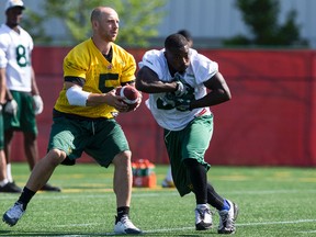 Edmonton Eskimos' Jordan Lynch (5) fakes a handoff to Shakir Bell (33) during a walkthrough at Clarke Stadium in Edmonton, Alta., on Friday July 24, 2015. The Eskimos play the Winnipeg Blue Bombers at Commonwealth Stadium in Edmonton on July 25 at 5 p.m.. Ian Kucerak/Edmonton Sun/Postmedia Network