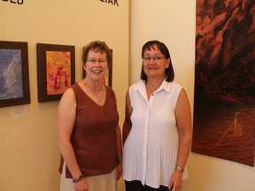 Artists Sharon Rubuliak (left) and Judy Weiss mingled with art enthusiasts on July 19 at the Multicultural Heritage Centre (MHC) in Stony Plain during the opening reception of their exhibit “Landed.” This exhibit will remain at the MHC until Aug. 10. - Karen Haynes, Reporter/Examiner