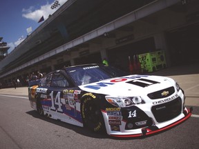 Tony Stewart drives through the garage area during practice for the Brickyard 400 on Friday. (AFP)