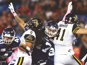 Argos special teams ace James Yurichuk blocks two Hamilton Tiger-Cats at once during a game last year. (AFP)