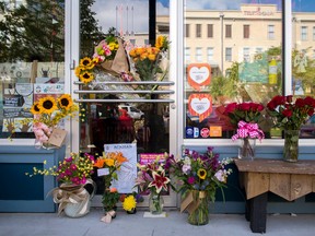 Flowers are left in front of Red Arrow Workshop in Lafayette, La., on Friday, July 24, 2015. The shop is co-owned by Jillian Johnson, who was killed during Thursday's shooting at The Grand Theatre in Lafayette.  (Brianna Paciorka /NOLA.com The Times-Picayune via AP)