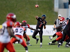 Ottawa Redblacks' Henry Burris makes a pass while taking on the Calgary Stampeders in second quarter CFL football action in Ottawa on Friday, July 24, 2015. THE CANADIAN PRESS/Sean Kilpatrick