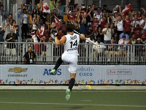 Canadian field hockey player Adam Froese celebrates the shootout winner against Brazil. (AFP)