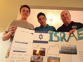 Brad Vincent, 17, to the left, Tal Cohen, 17, in the middle and Bryan Vincent, 57, on the right. Cohen is in Seaforth from Israel taking part in the International Youth Exchange Program. For an exercise in camp the exchange students had to make a project on bristle board explaining information about their country.(Shaun Gregory/Huron Expositor)