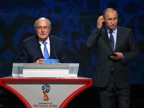 FIFA president Sepp Blatter addresses the gathering next to Russian President Vladimir Putin during the draw for World Cup qualifying at Konstantin Palace in St. Petersburg, Russia July 25, 2015. (REUTERS/Stringer)