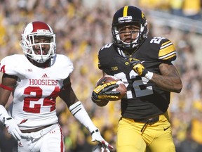 Wide receiver Damond Powell (right) of the Iowa Hawkeyes rushes for a touchdown as Tim Benneett of the Indiana Hoosiers chases during NCAA play at Kinnick Stadium in Iowa City last season. (Matthew Holst/Getty Images/AFP)