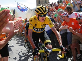 Chris Froome, wearing the overall leader’s yellow jersey, climbs towards Alpe d’Huez during the 20th stage of the Tour de France Saturday, July 25, 2015. (AP Photo/Laurent Cipriani)