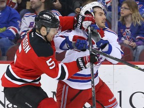 New Jersey Devils defenceman Adam Larsson (5) hits New York Rangers winger James Sheppard during NHL play at the Prudential Center. (Ed Mulholland/USA TODAY Sports)