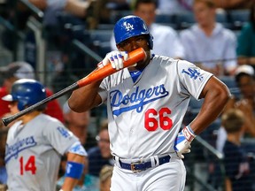 Yasiel Puig of the Los Angeles Dodgers reacts after a strike against the Atlanta Braves at Turner Field on July 21, 2015 in Atlanta.   (Kevin C. Cox/Getty Images/AFP)