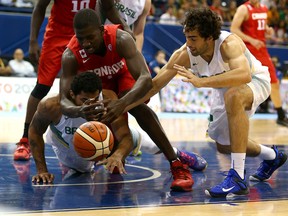 Team Canada’s Andrew Nicholson (left) scrambles for a loose ball against Team Brazil during Friday night’s gold-medal game. (DAVE ABEL/TORONTO SUN)