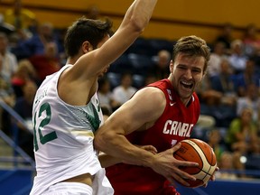 Aaron Doornekamp of Canada's men's basketball team is blocked by Rafael Hettsheimer of Brazil in the gold-medal game of the event during the 2015 Pan Am games in Toronto on July 25, 2015. (DAVE ABEL/Toronto Sun)