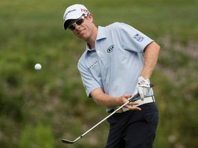 David Hearn, from Brantford, Ont., chips up onto the fourth green during third round of play at the Canadian Open golf tournament Saturday, July 25, 2015 in Oakville, Ontario. Hearn leads the Canadian Open by two strokes through three rounds and is in position to be the first Canadian to win the tournament since Pat Fletcher in 1954. (THE CANADIAN PRESS/Paul Chiasson)