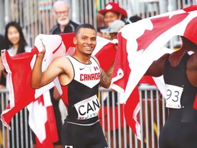 Canada’s Andre De Grasse celebrates after winning the 4x100 metre relay. The team was later disqualified for a lane violation. (STAN BEHAL/Toronto Sun)