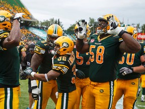 Edmonton Eskimos' Adarius Bowman (left) celebrates a touchdown on the Winnipeg Blue Bombers with teammates during the second half of CFL action at Commonwealth Stadium in Edmonton, Alta.. on Saturday July 25, 2015. Ian Kucerak/Edmonton Sun/Postmedia Network