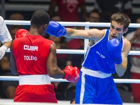 Canadian Arthur Biyarslanov (Blue) won gold over Yasnier Toledo of Cuba at the Pan Am Games. (Ernest Doroszuk, Toronto Sun)