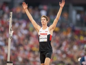 Derek Drouin of Canada celebrates his gold medal win in the men's high jump at the 2015 Pan American Games at CIBC Athletics Stadium in Toronto, Canada, July 25,  2015.  AFP PHOTO/GEOFF ROBINS