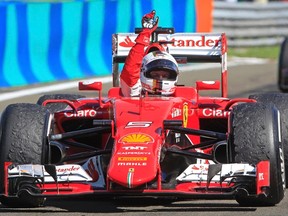 Ferrari driver Sebastian Vettel of Germany celebrates after winning the Hungarian Grand Prix at the Hungaroring circuit, near Budapest July 26, 2015. (REUTERS/Bernadett Szabo)