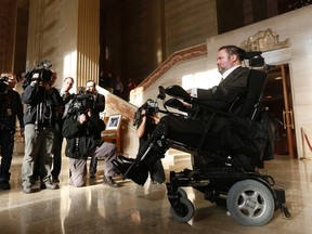 Conservative Member of Parliament Steven Fletcher (R) arrives to speak to journalists at the Supreme Court of Canada on Feb. 6, 2015. The Supreme Court of Canada overturned a ban on physician-assisted suicide on Friday, unanimously reversing a decision it made in 1993 and putting Canada in the company of a handful of Western countries where the practice will be legal. 
REUTERS/Chris Wattie