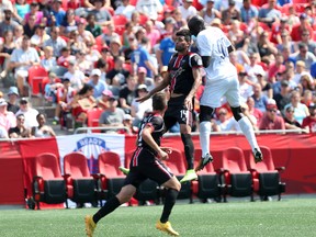 Ottawa Fury FC forward Aly Hassan and Carolina RailHawks defender Futty Danso battle for a ball in the air at TD Place on Sunday, July 26, 2015. (Chris Hofley/Ottawa Sun)