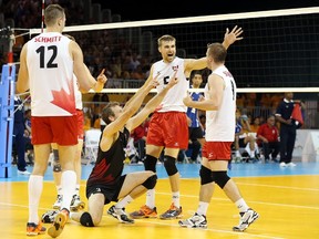 Daniel Lewis  of Canada (3) and Rudy Verhoeff of Canada (5) celebrate with Dustin Scheinder of Canada (9) against Puerto Rico in the men's volleyball bronze medal game during the 2015 Pan Am Game. (Kevin Hoffman/USA TODAY Sports)