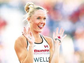 Canadian Sarah Wells, who won a silver in hurdling, shows off her hands painted with the words “I” and “Believe.” (AFP)