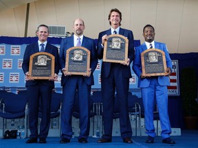 Hall of Fame inductees (from left) Craig Biggio, John Smoltz, Randy Johnson and Pedro Martinez show off their plaques during yesterday's ceremony at Cooperstown. (Mike Groll, AP)
