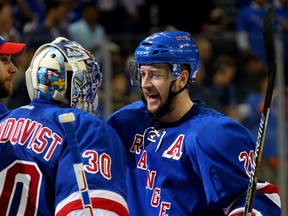 Henrik Lundqvist #30 and Derek Stepan #21 of the New York Rangers celebrate after defeating the Tampa Bay Lightning 2-1 in Game One of the Eastern Conference Finals during the 2015 NHL Stanley Cup Playoffs at Madison Square Garden on May 16, 2015 in New York City. (Bruce Bennett/Getty Images/AFP)