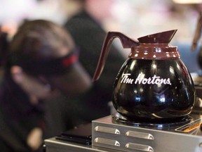 Freshly-brewed coffee sits on a hot plate in a Tim Hortons outlet in Oakville, Ont., on Sept. 16, 2013. Executives at Tim Hortons are reconsidering whether it's worth the risk of flavouring your coffee break with potential controversy. After the restaurant chain was dragged into a clash between environmentalists and oil industry supporters last month, Daniel Schwartz, CEO of Tim Hortons' parent company Restaurant Brands, said Monday the company is reviewing its Tims TV in-store digital screens. (THE CANADIAN PRESS/Chris Young)