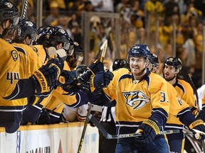 Colin Wilson #33 of the Nashville Predators is congratulated by teammates after scoring a power play goal against the Chicago Blackhawks during the third period of Game Five of the Western Conference Quarterfinals during the 2015 NHL Stanley Cup Playoffs at Bridgestone Arena on April 23, 2015 in Nashville, Tennessee.   (Frederick Breedon/Getty Images/AFP)