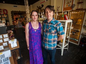 In this July 31, 2014 photo, Jillian Johnson and Jason Brown, husband and wife and co-owners of Red Arrow Workshop, pose for a photo in their shop in River Ranch in Lafayette, La. Johnson was slain by a gunman who opened fire Thursday, July 23, 2015, in a crowded Louisiana movie theater. Johnson, 33, was remembered as an all-around "creative force" who ran clothing and art boutiques, played in a rootsy rock band, helped organize a music festival, and used her design skills on T-shirts and other crafts. (Paul Kieu/The Daily Advertiser via AP)