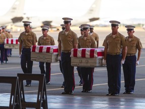U.S. Marines carry the remains of 36 unidentified Marines found at a Second World War battlefield during a ceremony at Joint Base Pearl Harbor-Hickam, in Honolulu, on July 26, 2015. (AP Photo/Marco Garcia)