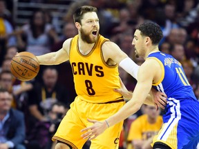 Cleveland Cavaliers guard Matthew Dellavedova (8) handles the ball against Golden State Warriors guard Klay Thompson (11) during the first quarter in game four of the NBA Finals at Quicken Loans Arena. Bob Donnan-USA TODAY Sports