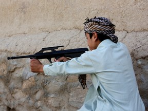 In this Saturday, July 25, 2015 photo, an Afghan boy plays with his friends using a toy gun, in Kabul, Afghanistan. At least 184 people, nearly all children, suffered eye injuries over the recent Eid al-Fitr holiday from toy weapons that fire BB pellets and rubber shot, health officials said. In response, authorities have called on police to destroy all the toy guns officers comes across. (AP Photo/Rahmat Gul)