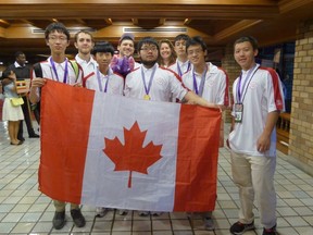 Left to right: Jinhao (Hunter) Xu, James Rickards (Observer), Kevin Sun, Jacob Tsimerman (Leader), Zhuo Qun (Alex) Song, Lindsey Shorser (Deputy Leader), Alexander Whatley, Michael Pang, Yan (Bill) Huang are shown at the International Mathematical Olympiad in Thailand on July 16, 2015. Alex Song, 18, won the International Mathematical Olympiad in Thailand in mid-July, achieving the rare perfect score in the two-day competition against more than 600 high school competitors from 104 countries. (THE CANADIAN PRESS/HO-Canadian Mathematical Society)